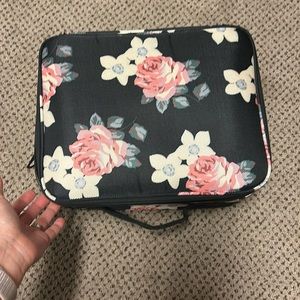 Makeup case from Amazon. Black with flowers. No strap. No dividers